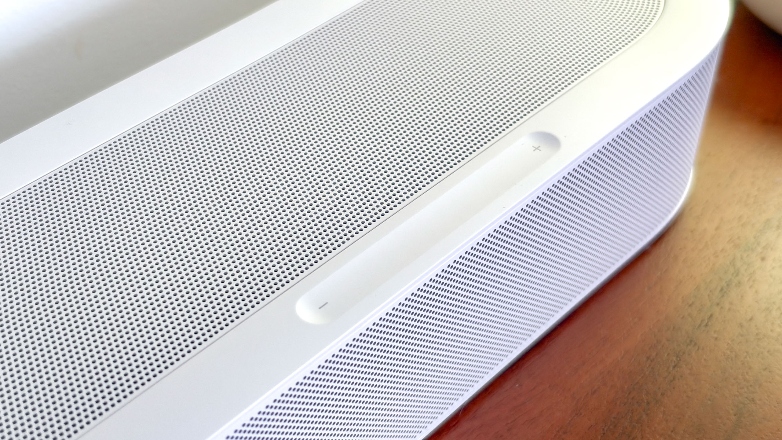 A Sonos Beam Ultra soundbar on a side table