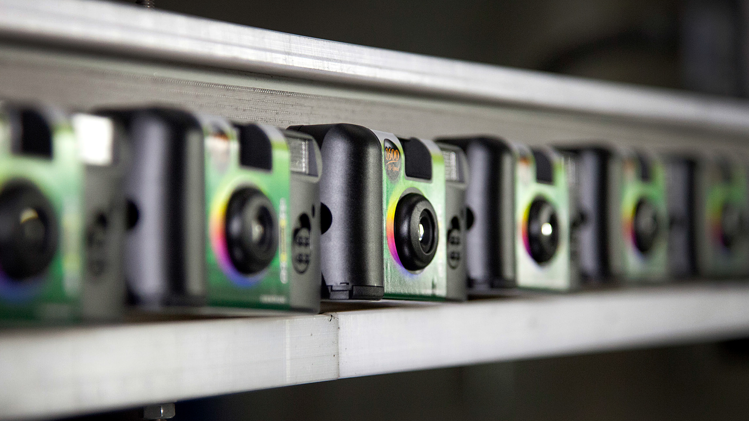 Finished Fujifilm Holdings Corp. QuickSnap disposable cameras move along a conveyor belt at the company's production facility in Greenwood, South Carolina, U.S., on Thursday, Jan. 12, 2012. Photographer: Ariana Lindquist/Bloomberg via Getty Images