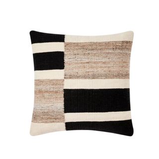 A black, white, and brown throw pillow