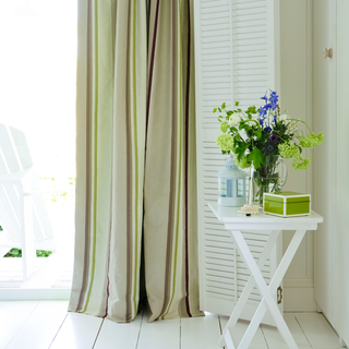 curtains with table and flower vase
