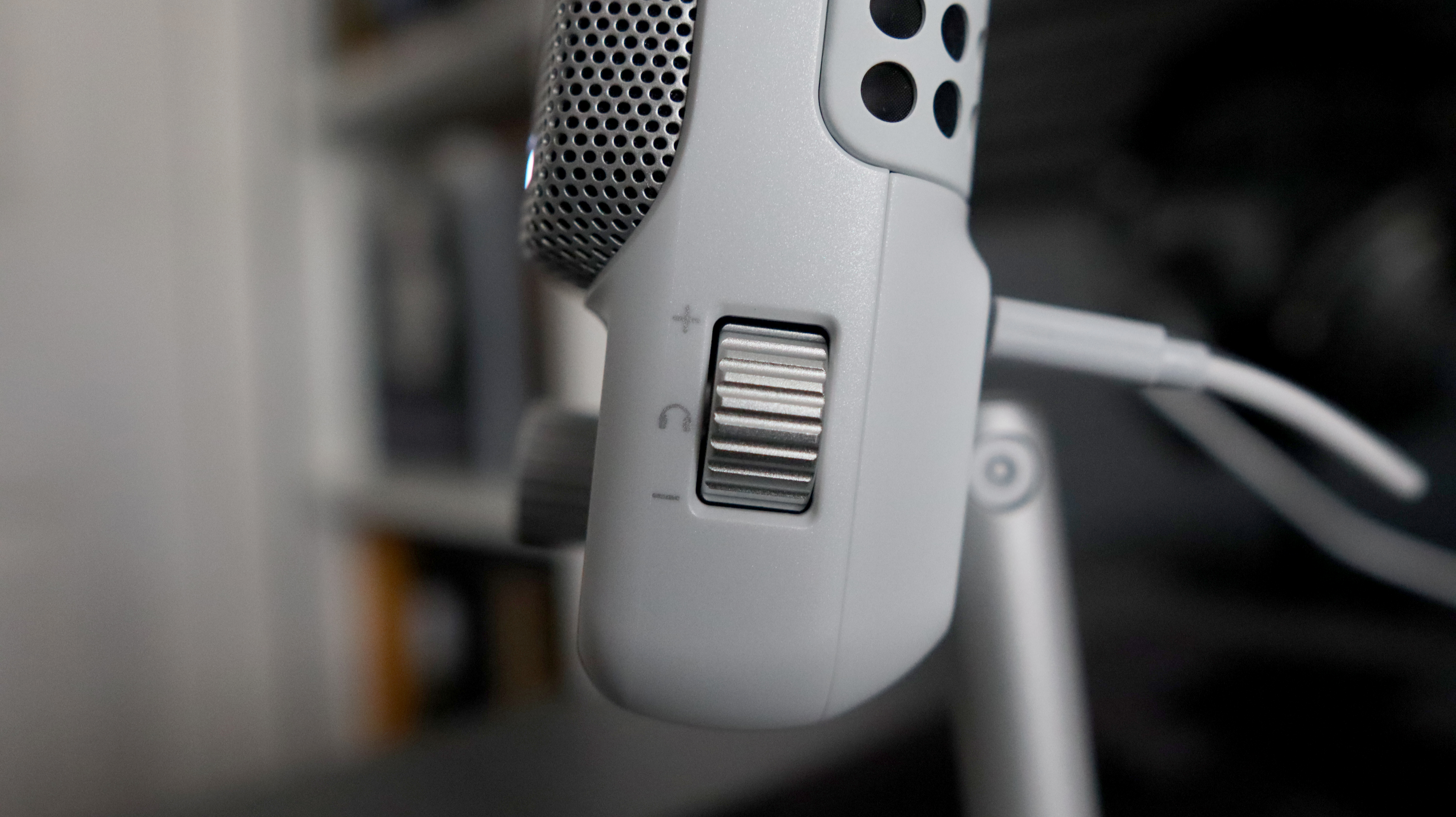 An NZXT Capsule Elite microphone set up on a desk with lighting enabled.