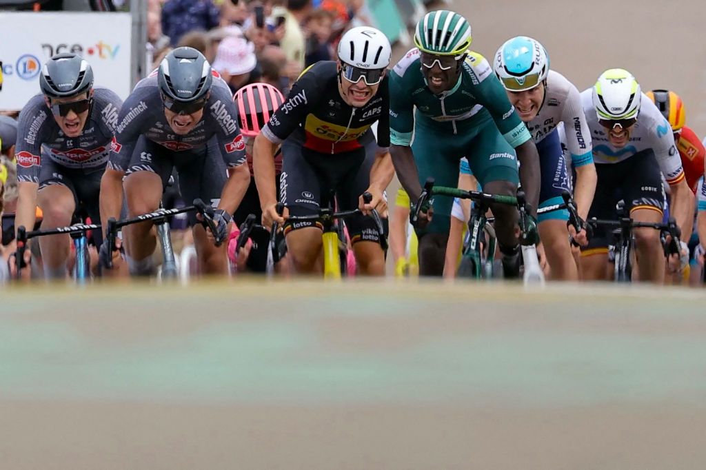 Intermarche - Wanty team's Eritrean rider Biniam Girmay (3rd R) wearing the sprinter's green jersey sprints the finish line to win ahead of second-placed Alpecin-Deceuninck team's Belgian rider Jasper Philipsen (2nd L) and third-placed Lotto Dstny team's Belgian rider Arnaud De Lie (C) during the 8th stage of the 111th edition of the Tour de France cycling race, 183,5 km between Semur-en-Auxois and Colombey-les-deux-Eglises, on July 6, 2024. (Photo by Thomas SAMSON / AFP)