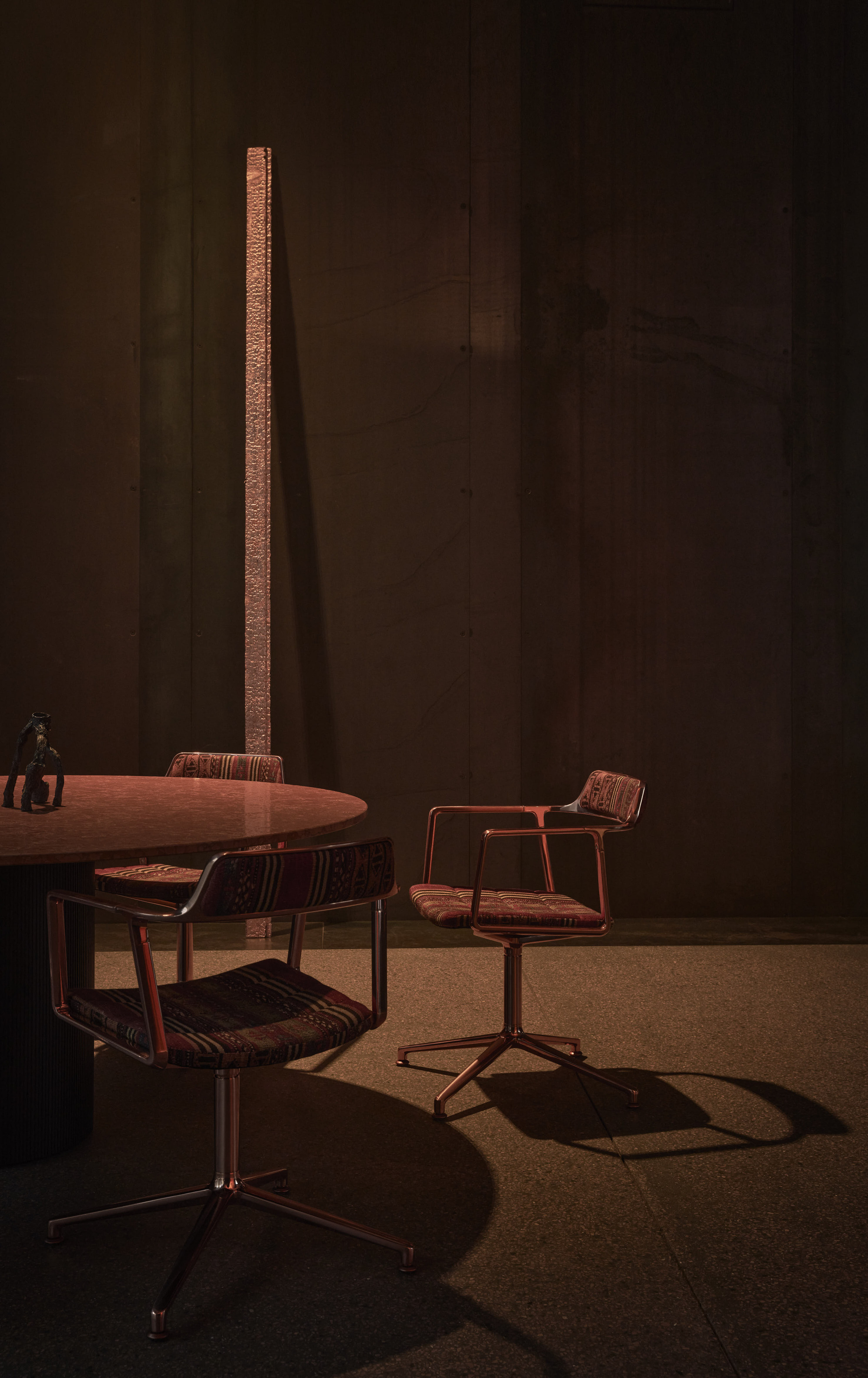 dark space with berber fabric chairs, marble floors, and round table