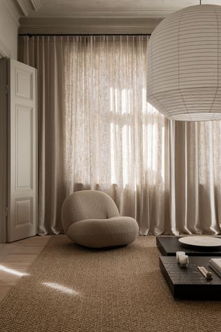 A minimalist room with sheer curtains