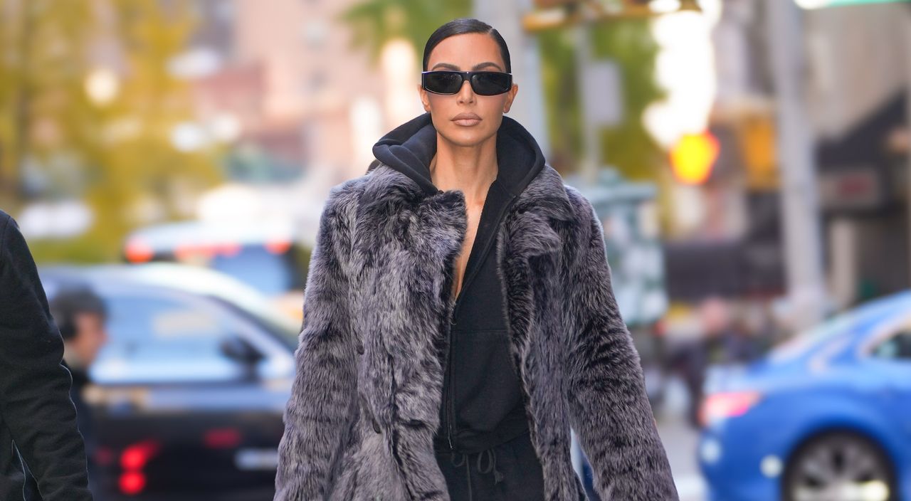 kim kardashian wears a giant fur coat with black sweats and a maxi birkin bag in nyc