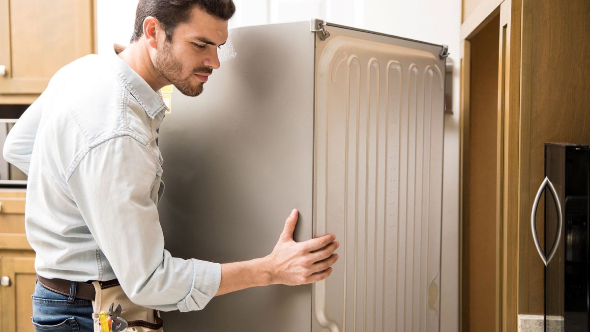 Man moving refrigerator