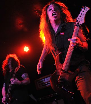 Dave “Snake” Sabo (left) and Scotti Hill perform onstage with Skid Row at the Manchester Academy in Manchester, England on October 24, 2013