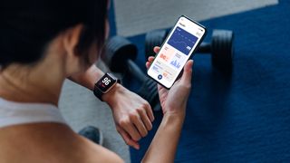 A woman looks at her fitness tracker