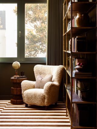 striped rug, fluffy textured cream armchair