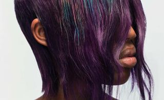Model with multicoloured hair, using colour-changing hair dye