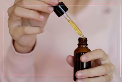 close up of woman demonstrating how to use essential oils with a pipette from the bottle