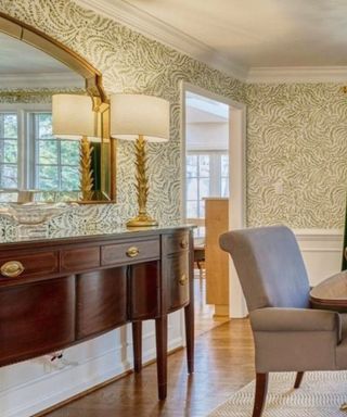 Dining room dressed with an antique sideboard agains the back wall, topped with an oversized mirror