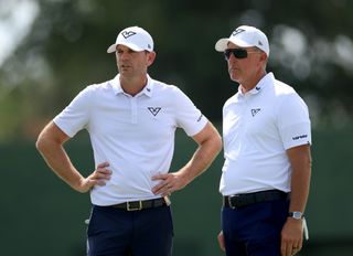 Brendan Steele and Phil Mickelson chat on the putting green