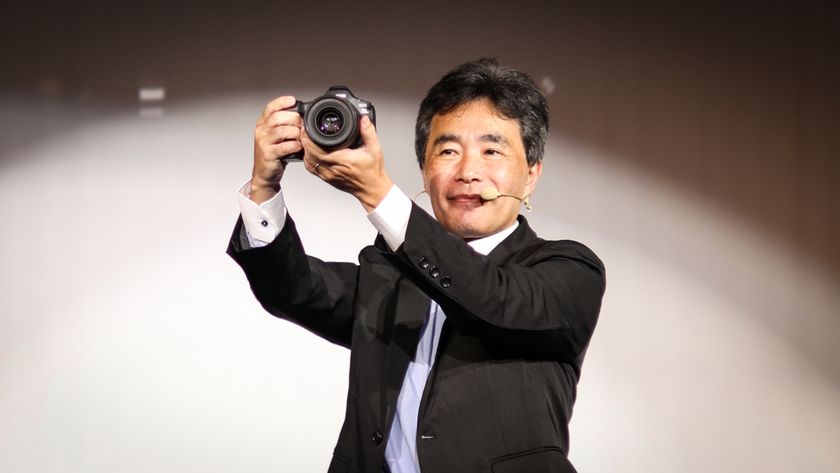 Canon executive Manabu Kato holds the Canon EOS R5 Mark II at the official product announcement