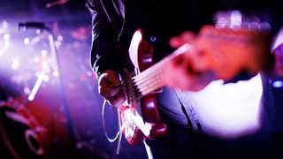 Close up of a musician playing the electric guitar during a concert