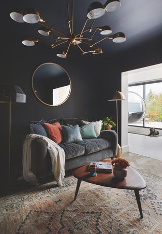 dark blue living room with modern chandelier lighting