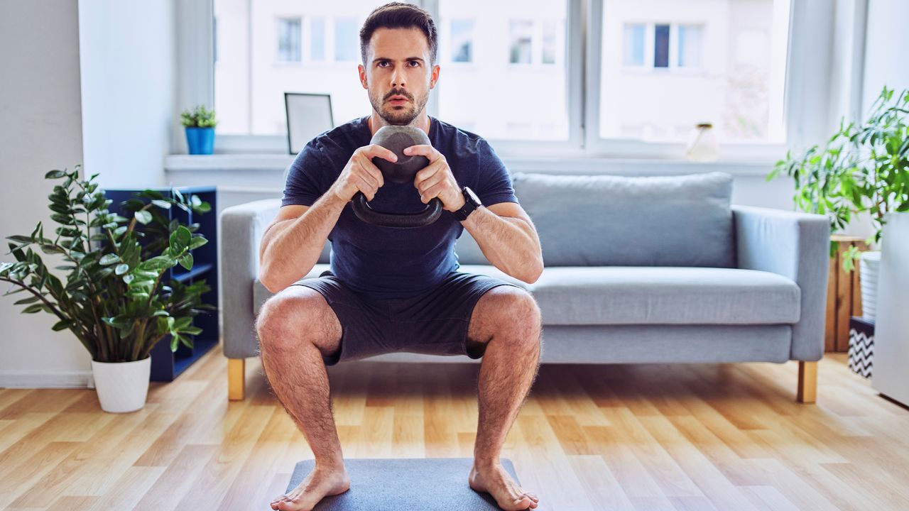 Man doing a kettlebell squat