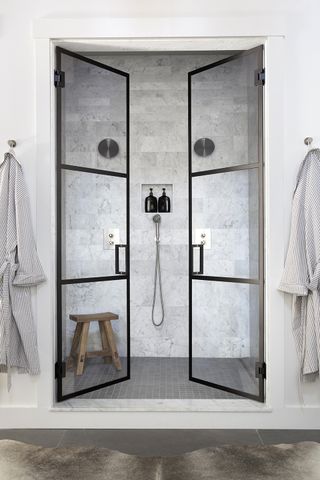 A shower with black framed shower doors