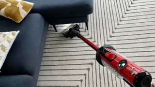 Henry Quick vacuuming a rug