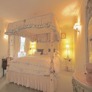 bedroom with four poster bed and bedside table with lamp