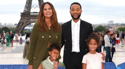 Chrissy Teigen and John Legend attend with son Miles and daughter Luna the red carpet ahead of the opening ceremony of the Olympic Games Paris 2024 on July 26, 2024 in Paris, France.