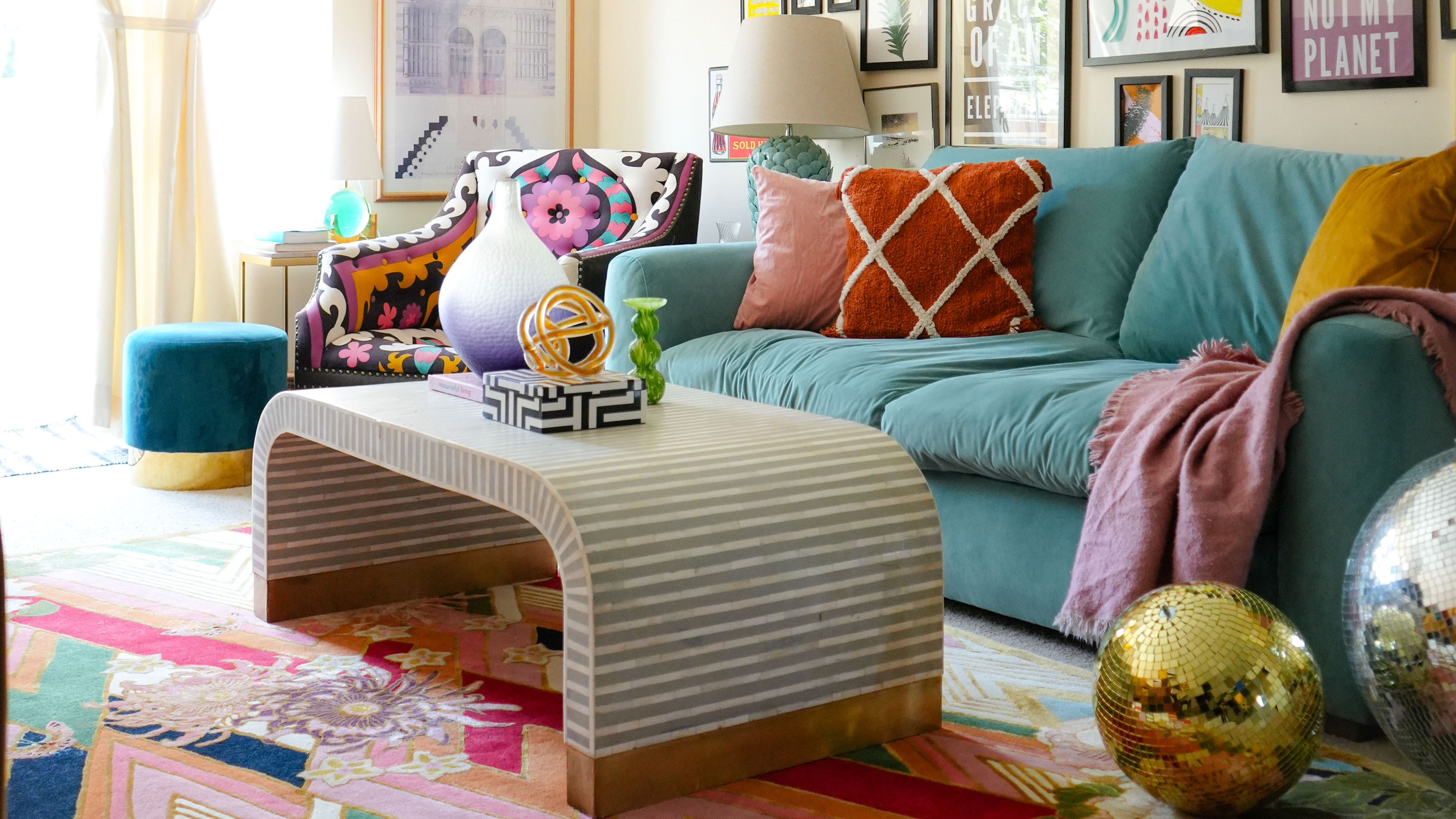 Colourful and eclectic living room with bright green sofa and multi-coloured rug
