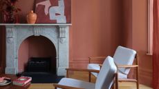 Terracotta living room featuring an ornate stone fireplace and mid-century-style furniture