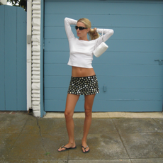Megan in long-sleeved tee, sparkly skirt and flip-flops