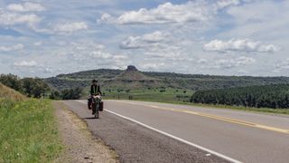 bikepacker cycling on road