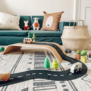 An IKEA Sigfinn Monitor Stand that has been reemployed as a car racing track in a kids room