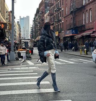 Influencer wears jeans tucked into boots.