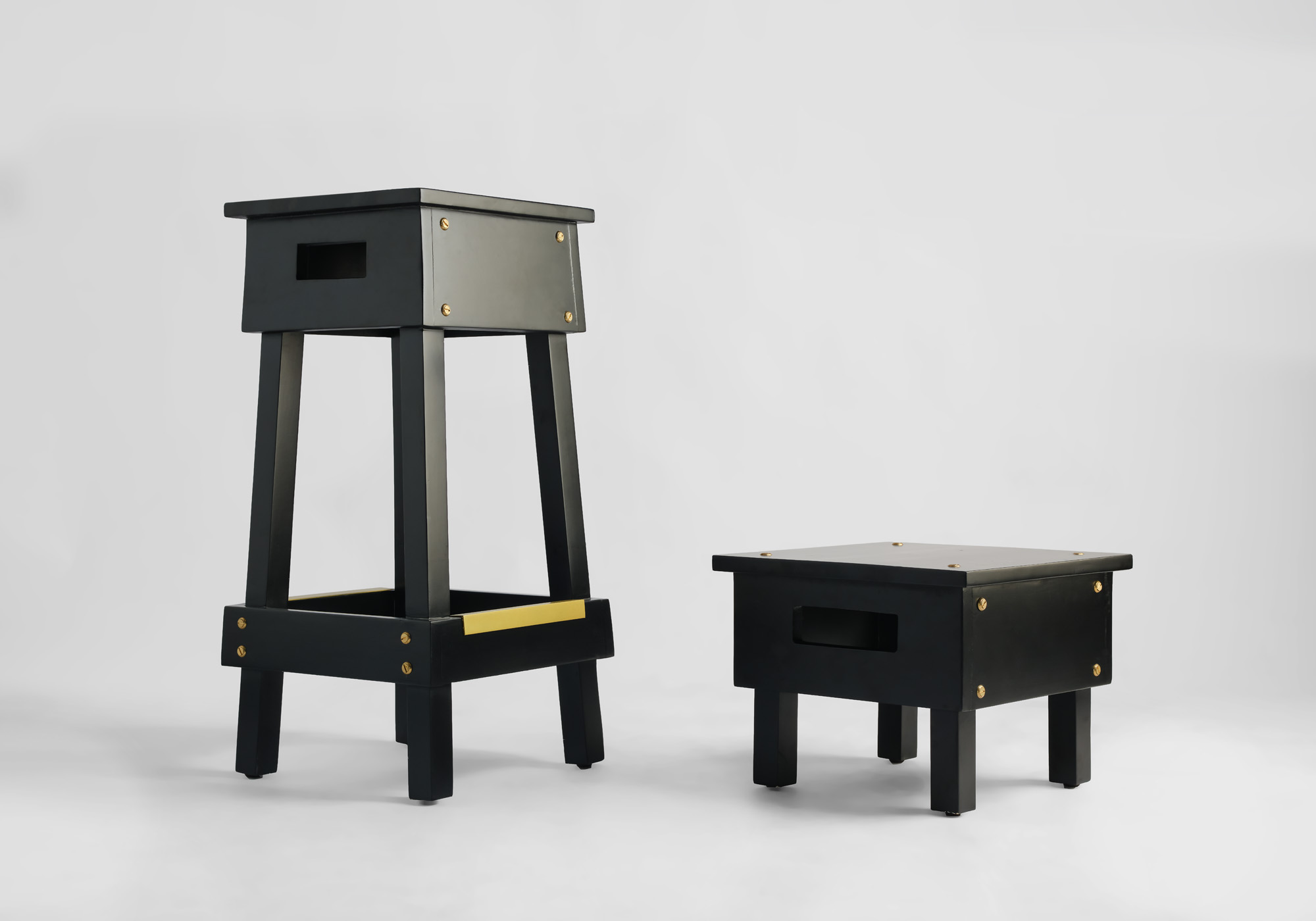 Black stools of two different heights by Tosin Oshinowo