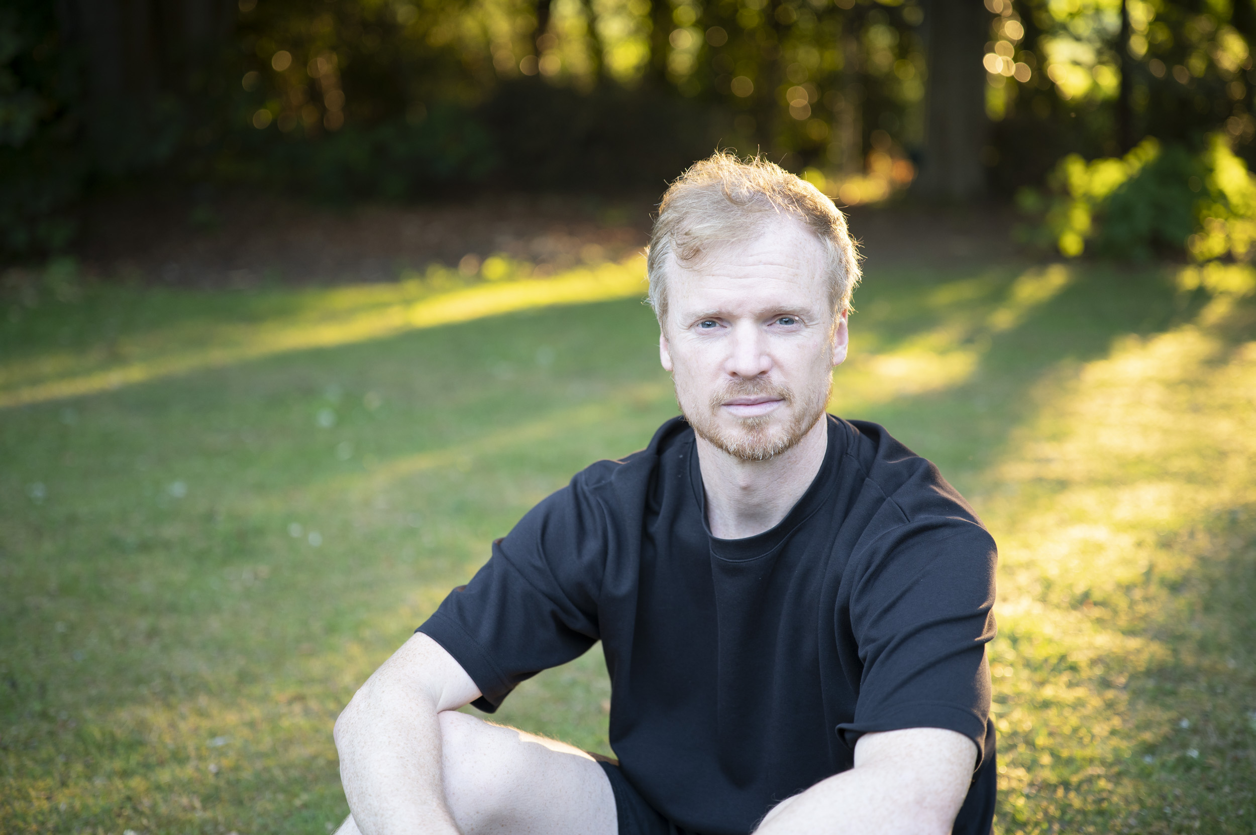 Portrait of a man during golden hour with dappled light through trees, taken with the Viltrox AF 50mm F2 Air lens