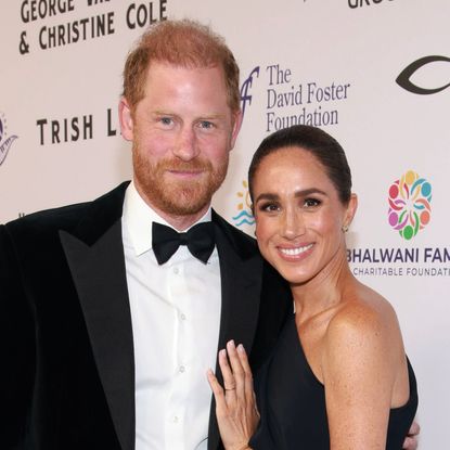 Meghan Markle wears a long black dress with Princess Diana's butterfly earrings