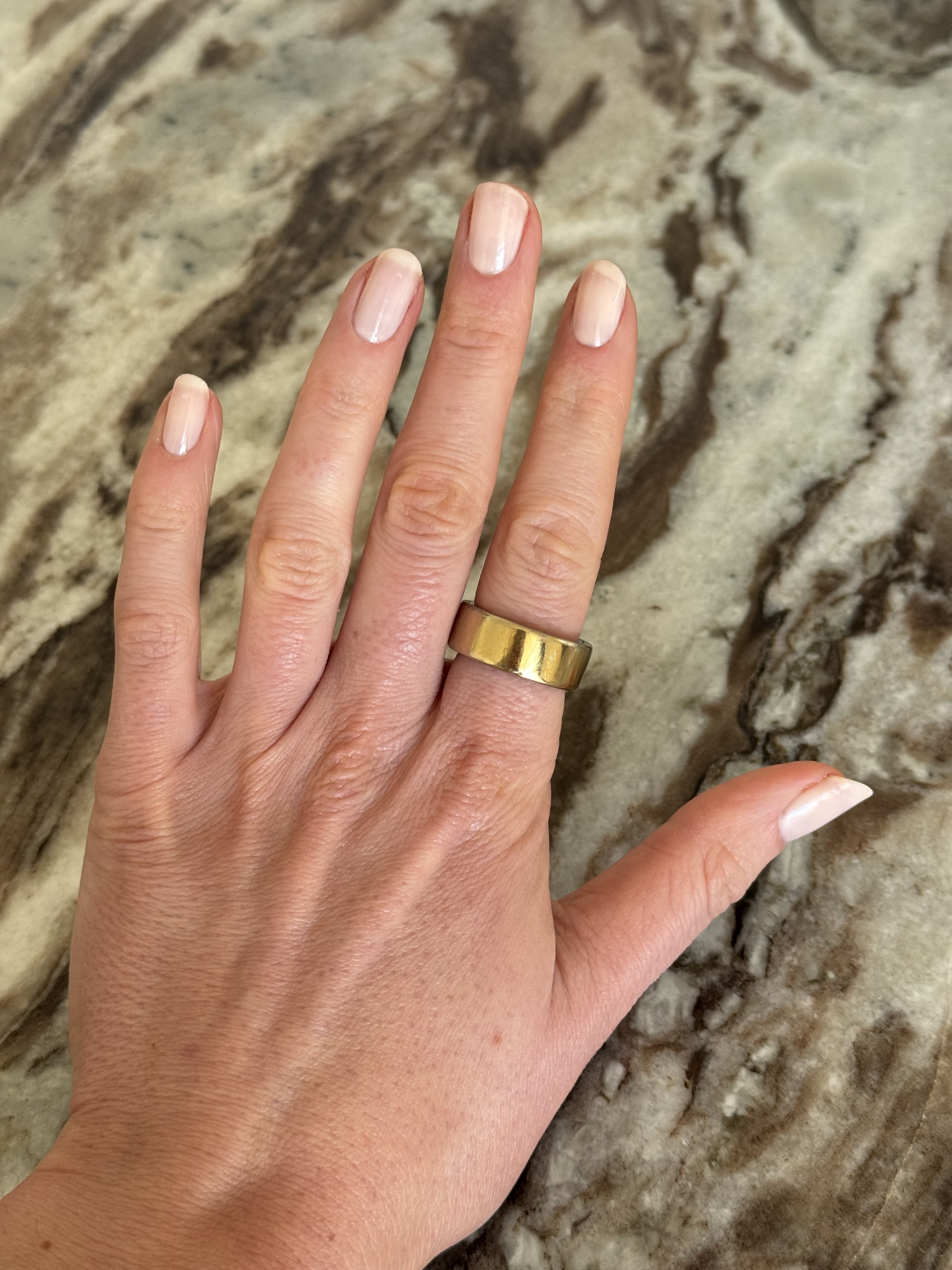 A photo of Eleanor's hand wearing Essie Fairy Tailor