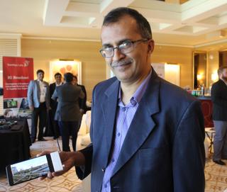Vasanth Shreesha holds a cellphone enabled for ASTC 3.0 reception via a Saankhya prototype dongle.