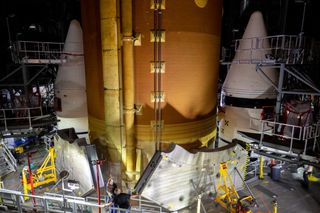 A view of the core stage positioned in between its two solid rocket boosters, that will give the heavy lifter an extra kick on liftoff.