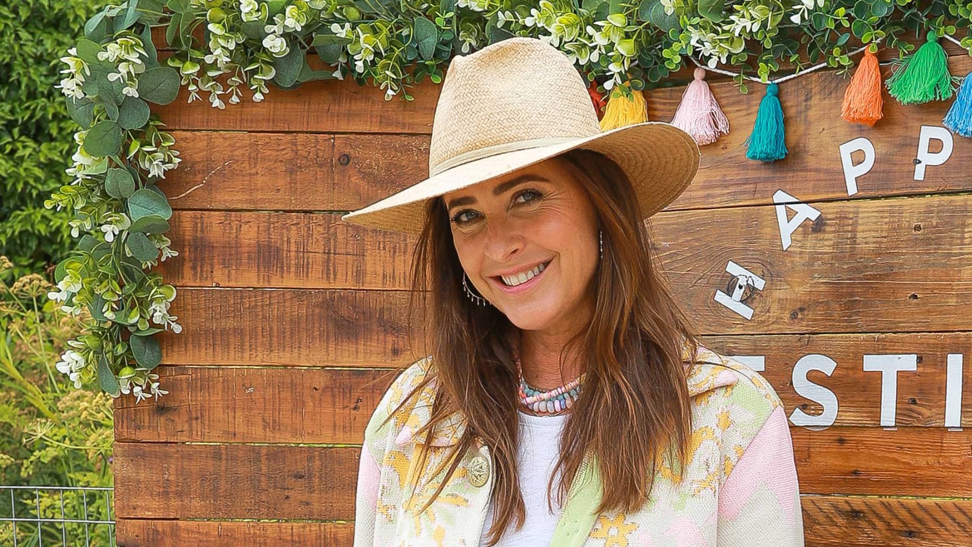 a headshot of lisa snowdon wearing a wide brim hat