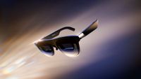 XREAL 1 Pro+ AR glasses floating against a dark background with light reflections highlighting the frames and lenses.