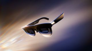 XREAL 1 Pro+ AR glasses floating against a dark background with light reflections highlighting the frames and lenses.