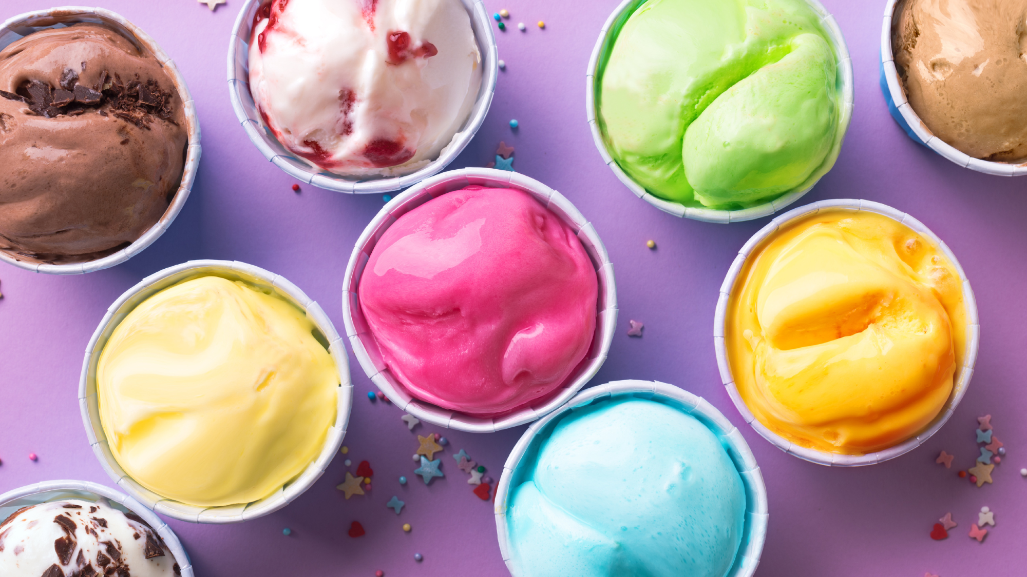 A range of ice creams and gelato laid out on a table
