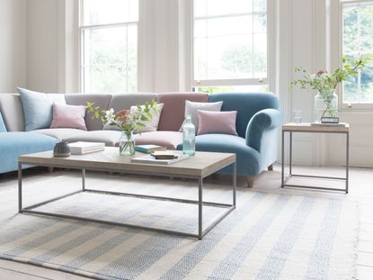 striped rug with coffee table and sofa in living room