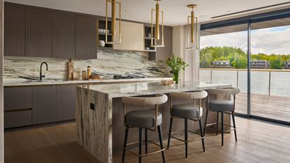 luxury kitchen with large marble island and taupe handless cabinets