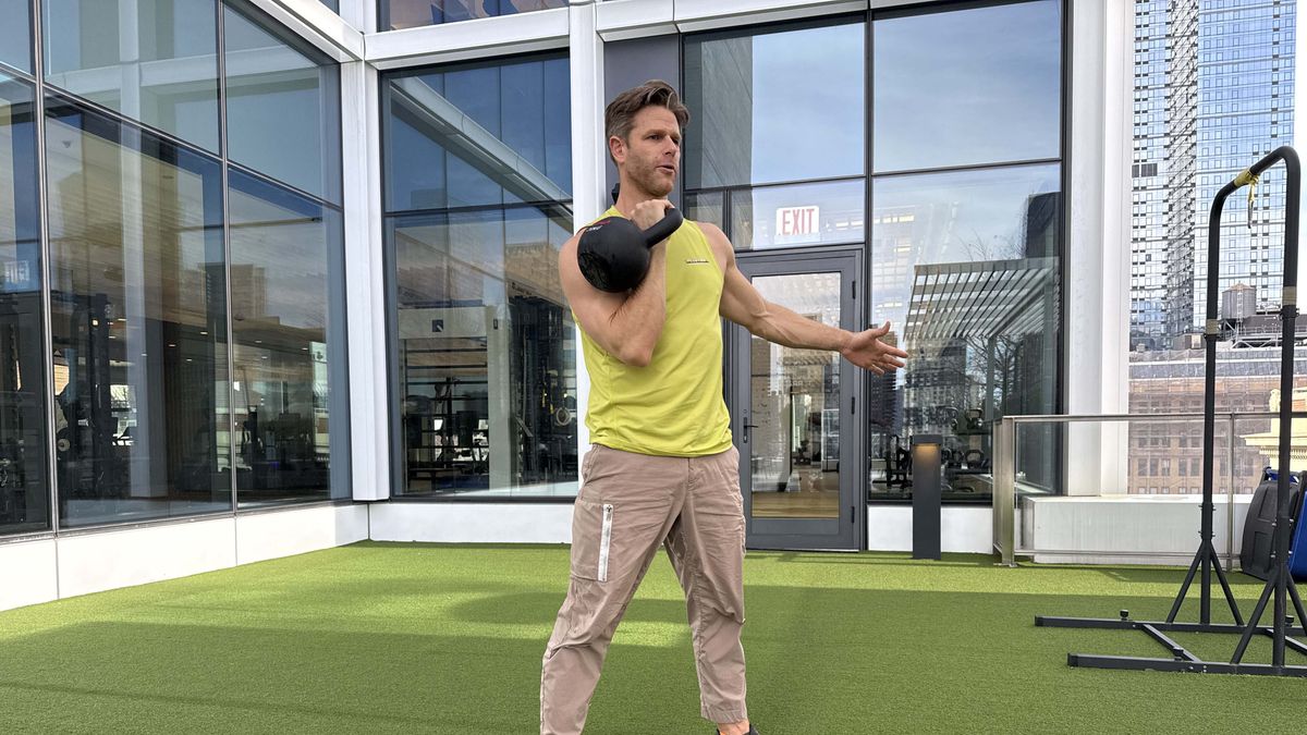 a photo of Peloton trainer Andy Speer doing a kettlebell single-arm clean