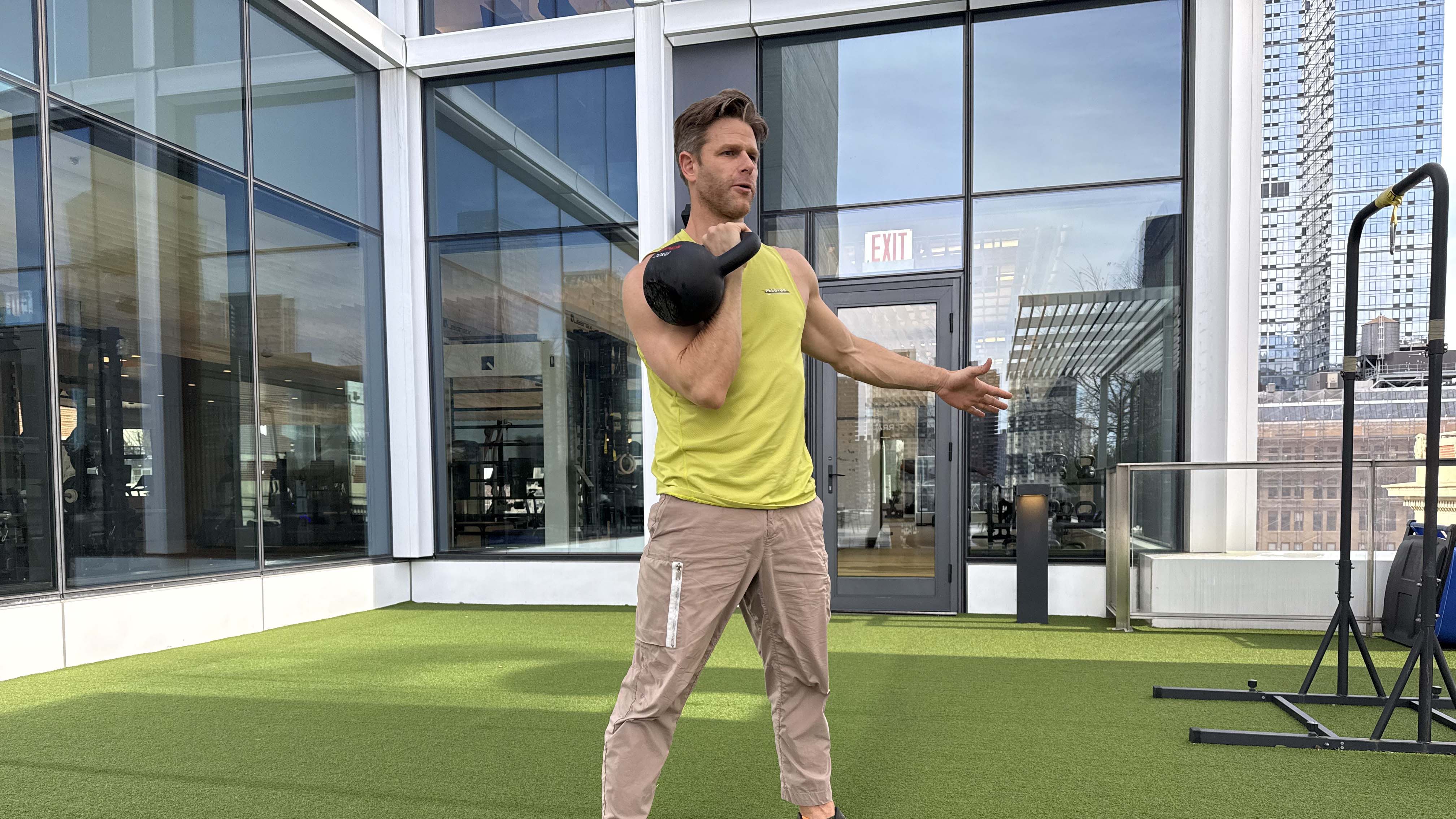 a photo of Peloton trainer Andy Speer doing a kettlebell single-arm clean