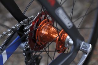 An orange Chris King hub fitted to a Boardman bike