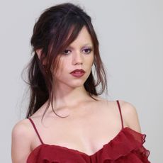 Jenna Ortega wears a red dress at Paris Fashion Week