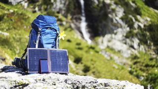how to charge phones while camping: solar charger and hiking backpack