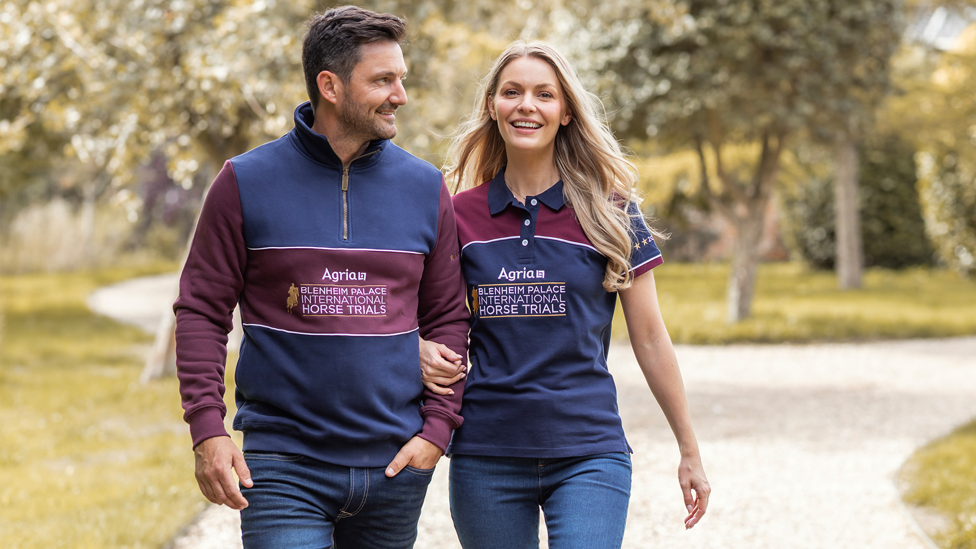 Man and woman walking together wearing Blenheim Horse Trials merchandise