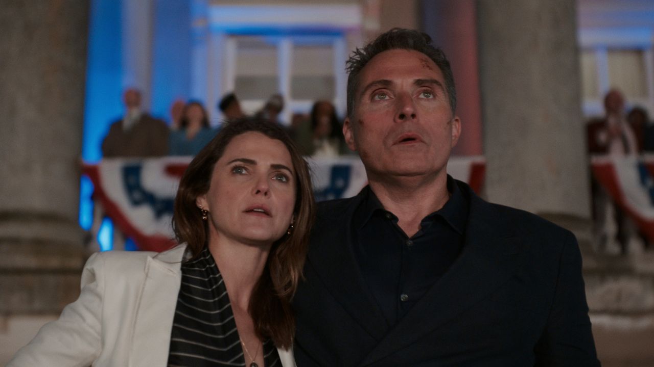 keri russell and rufus sewell as kate and hal wyler in the diplomat season 2 at an event staring off into the distance